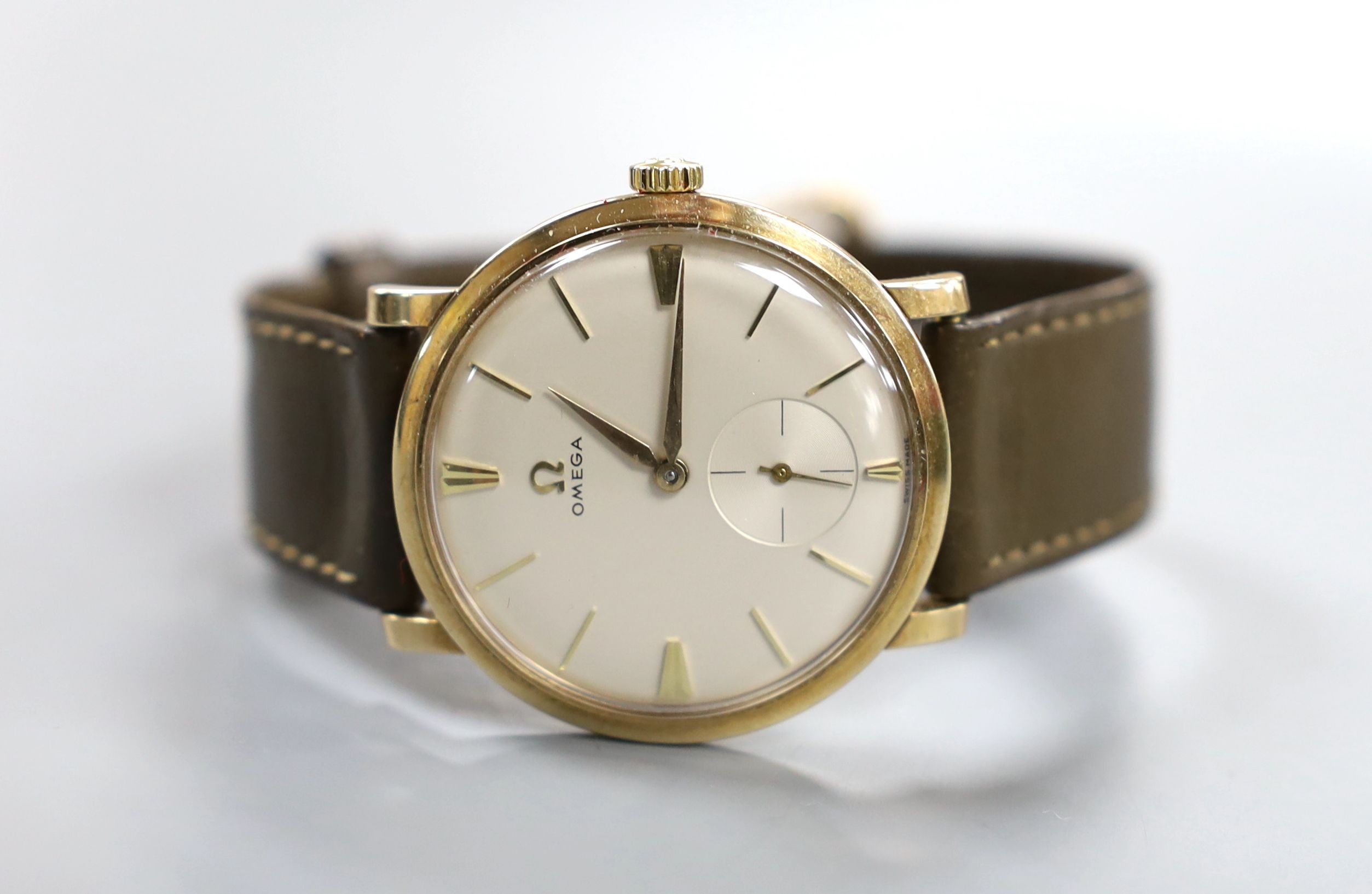 A gentlemen's late 1950's 9ct gold Omega manual wind wristwatch, on Omega leather strap with 9ct gold buckle, cased diameter 34mm, gross weight 30 grams, with Omega box.